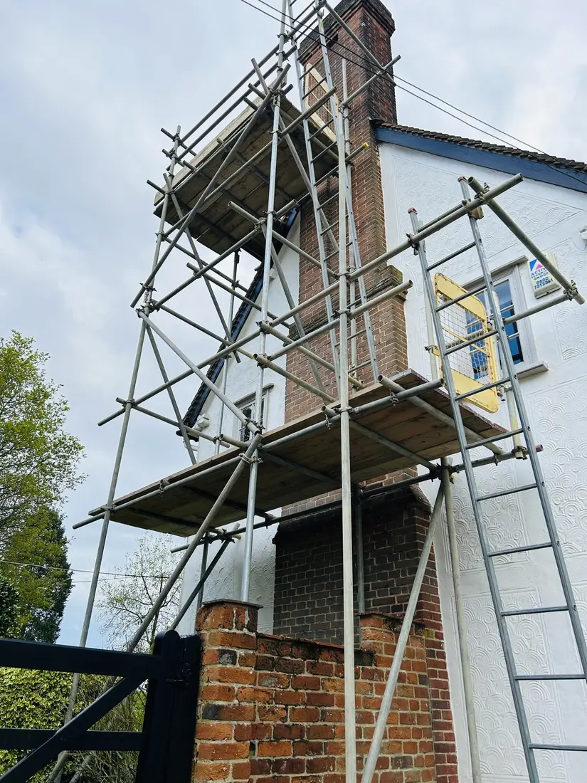 Chimney scaffold beside a pargeted wall by Falcon Scaffolding