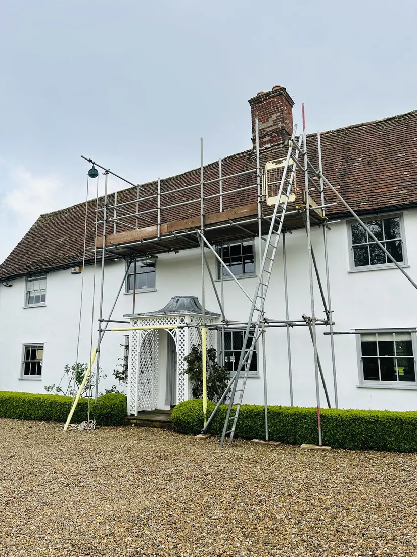 Roof repair scaffold with gin wheel on a farmhouse