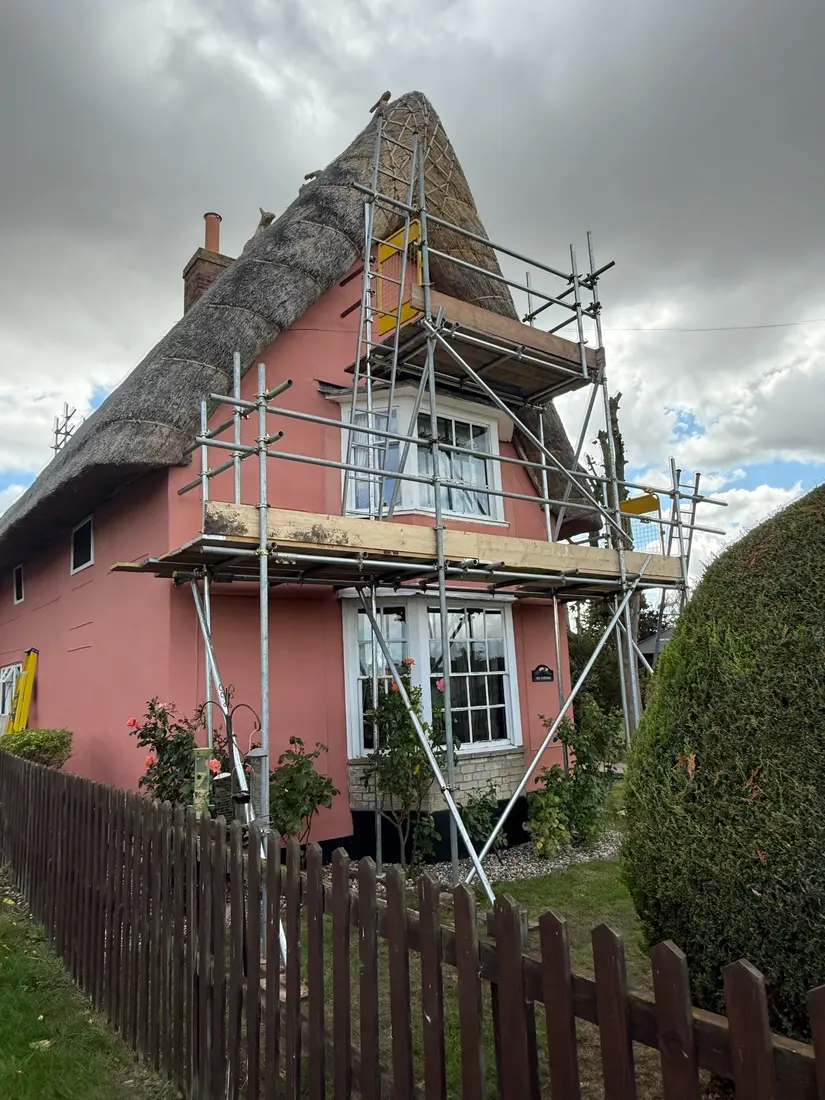 Scaffolding on a pink thatched cottage by Falcon Scaffolding
