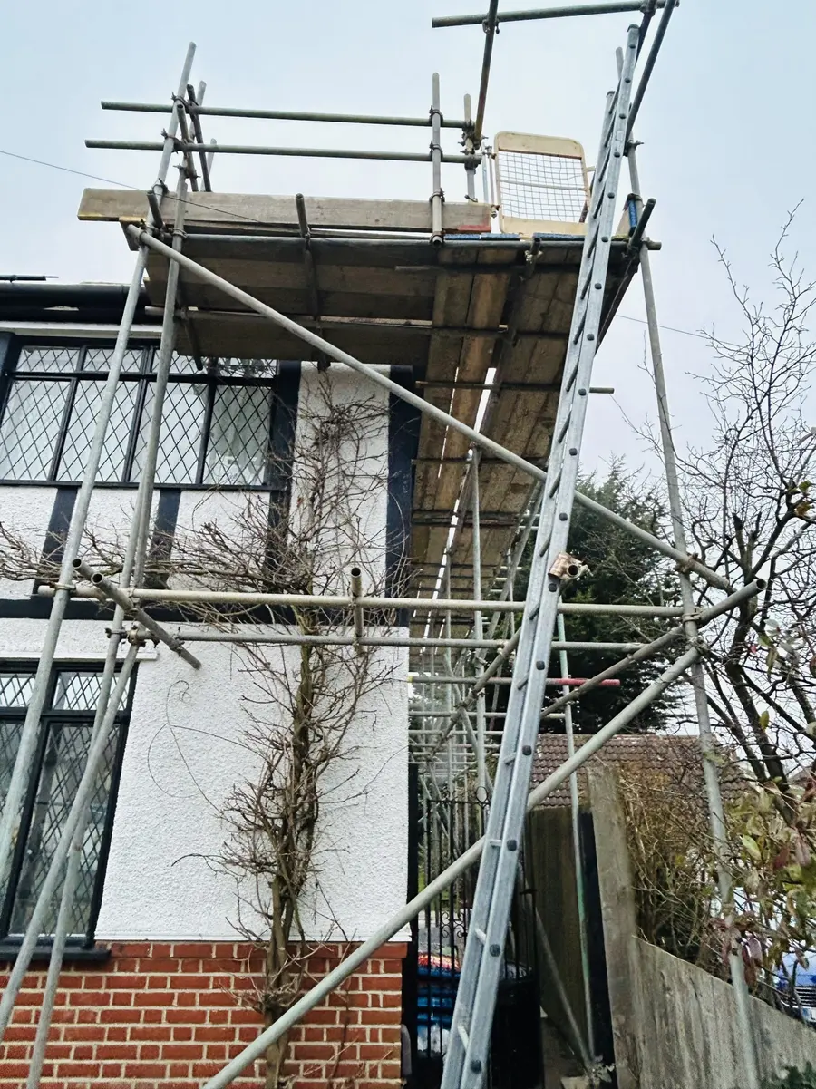 Scaffold platform beside leaded windows – Platform at roof level by Falcon Scaffolding